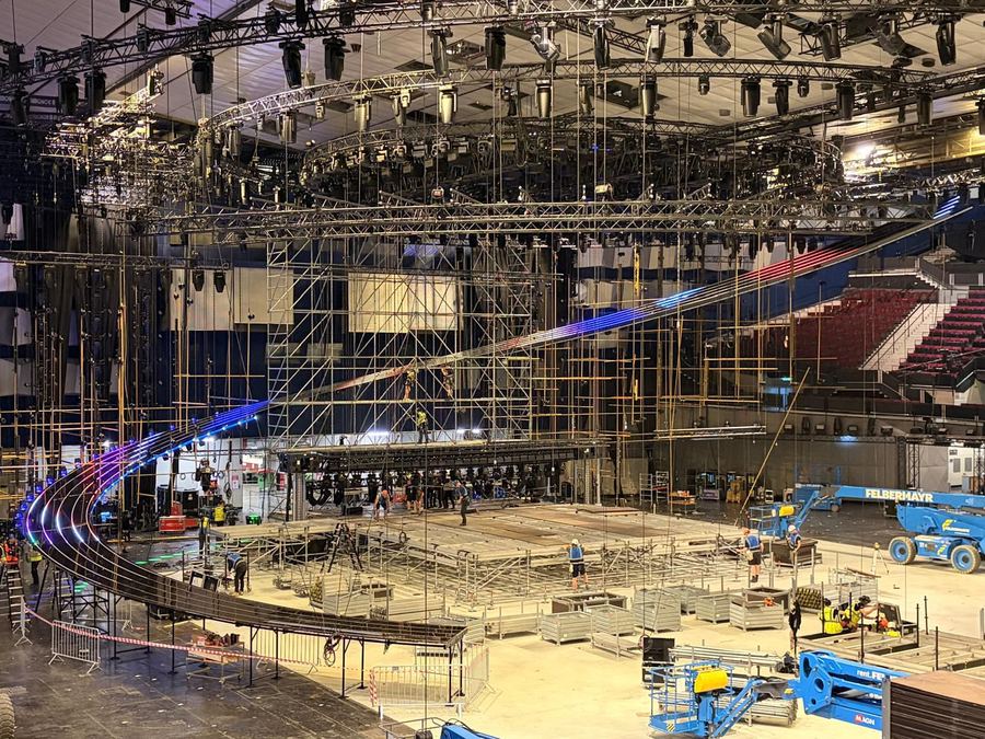 Arena stage with red LED screens and lighting rig